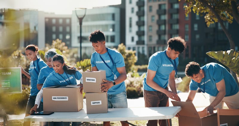 A group of people in blue volunteer shirts working outdoors